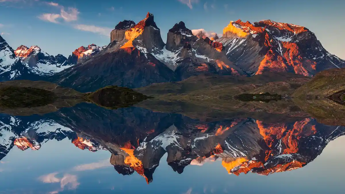 In Torres del Paine National Park, Patagonia, majestic Cuernos del Paine granite peaks rise over 6,500 feet. Their…