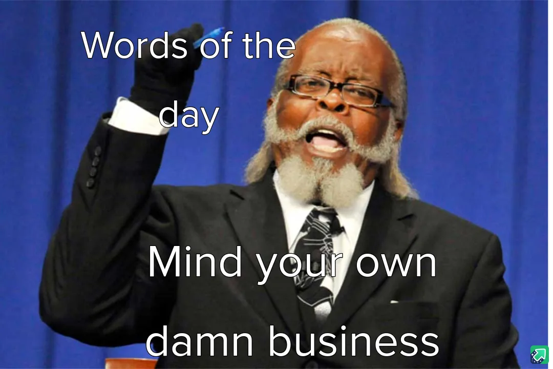 A man in a black suit and tie, wearing glasses and a white beard, stands before a blue curtain with his right hand raised…