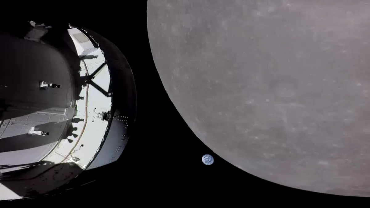 A spacecraft is shown in space next to the moon, with the Earth visible as a tiny blue dot in the distance. The overlaid…