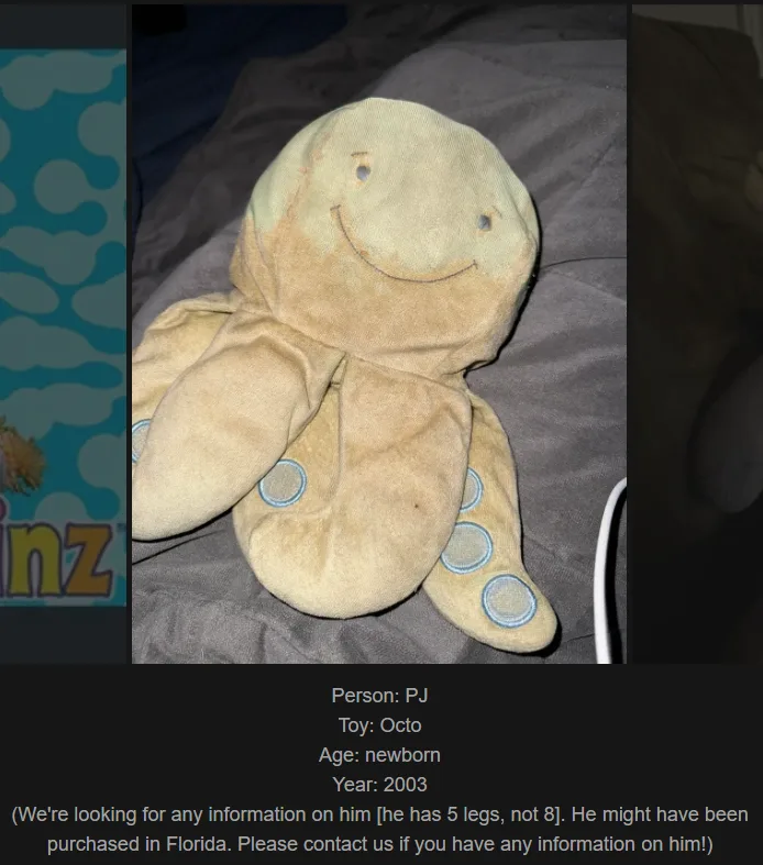A worn, beige plush octopus toy with a stitched smiley face and blue-ringed suction cups on its tentacles lies on a gray…