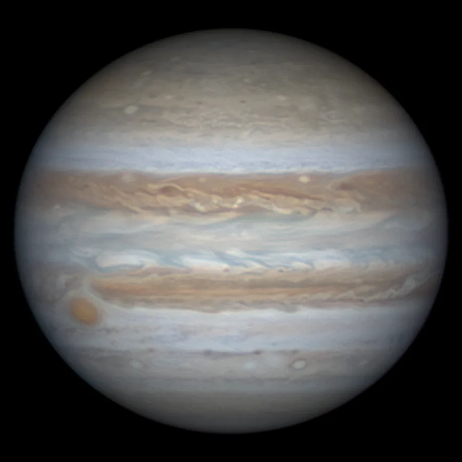 A high-resolution image of the planet Jupiter, showing its iconic swirling bands of beige, white, and light brown clouds…