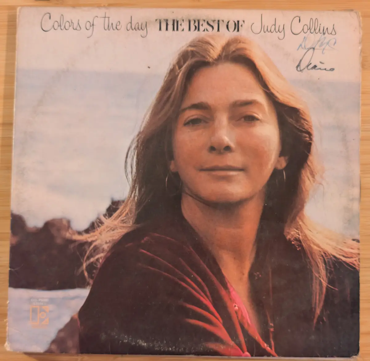 A vintage album cover for 'Colors of the day THE BEST OF Judy Collins' shows a woman with long hair and hoop earrings…