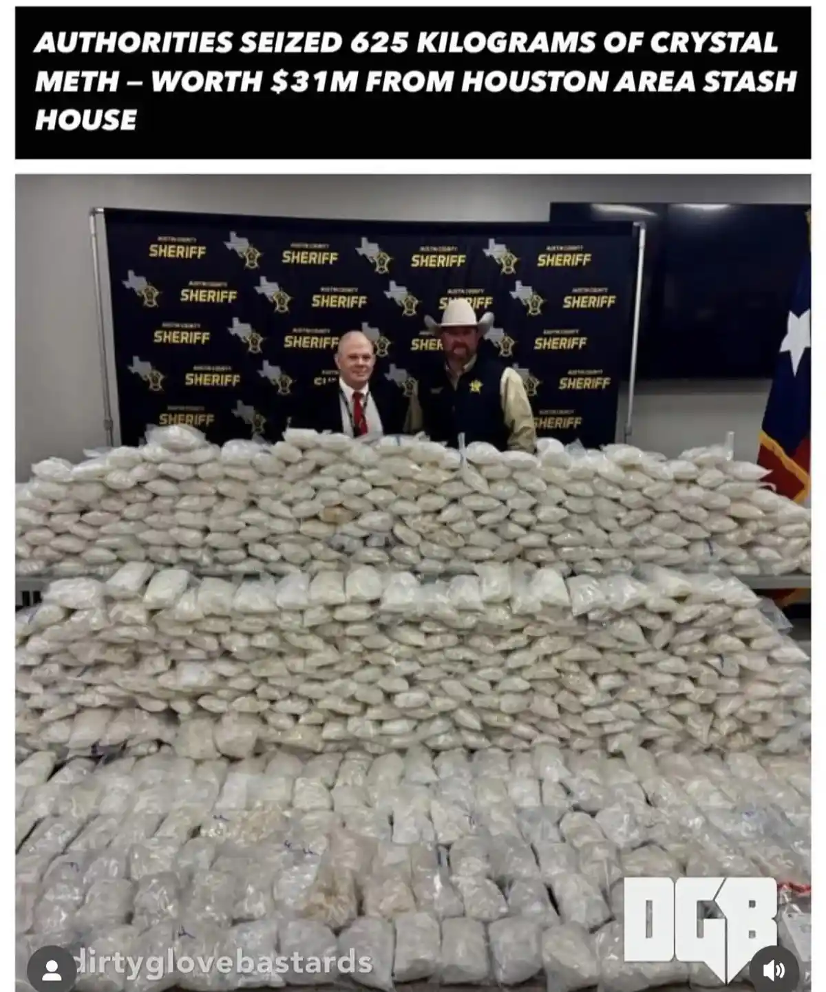 Two men, one in a suit and one in a sheriff's uniform with a cowboy hat, stand behind a massive pile of plastic bags filled…
