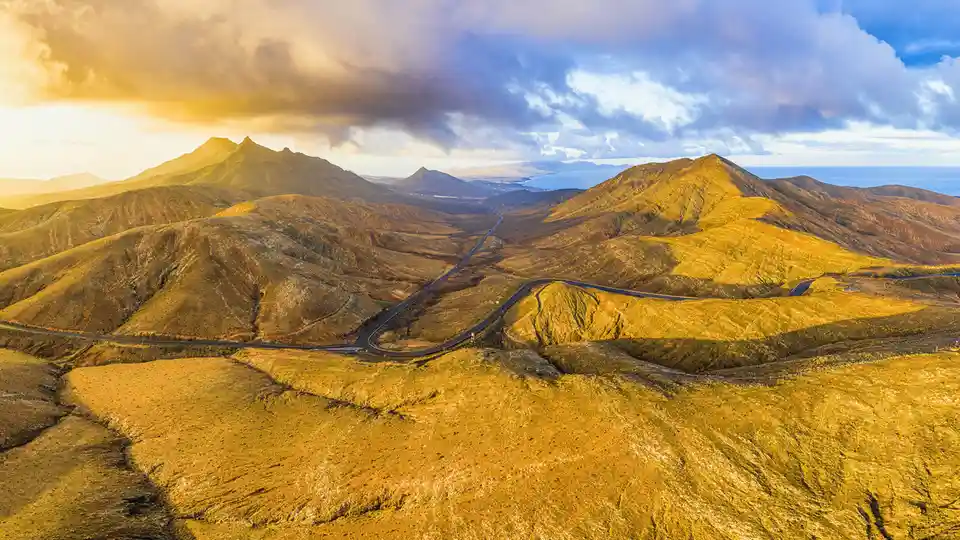 Fuerteventura's dramatic landscape contrasts vividly - windswept beaches and crystal Atlantic waters meet arid plains and…