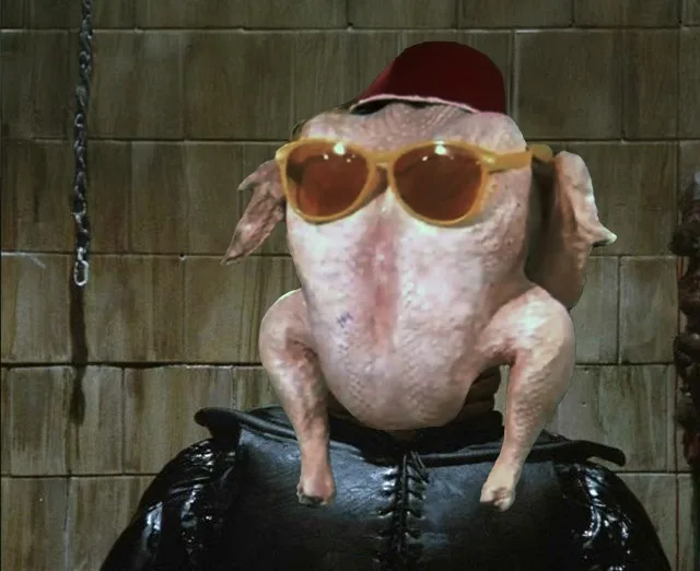 A raw, plucked chicken is digitally edited to wear a red fez and orange-tinted sunglasses, perched on a person's shoulders…