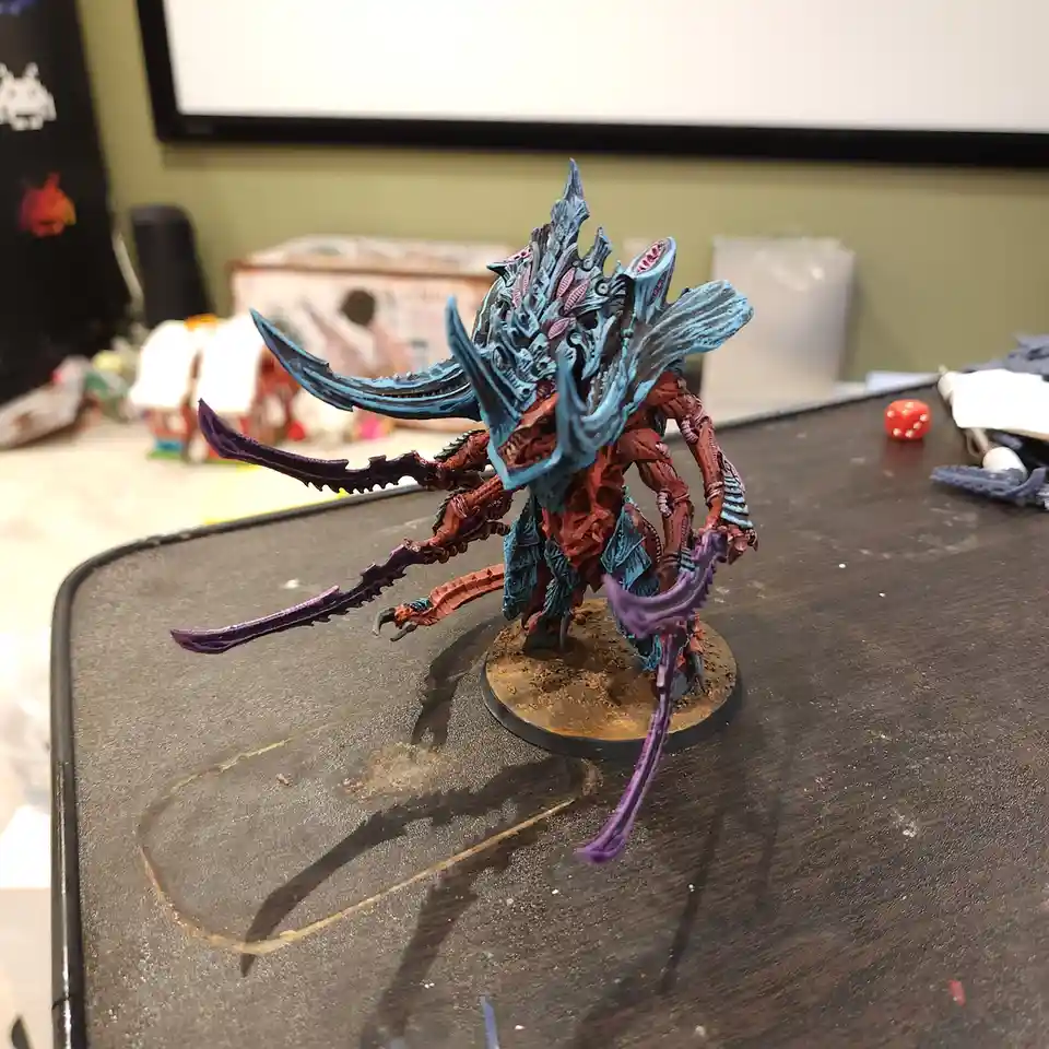 A highly detailed, painted fantasy miniatures figure with a blue and red color scheme, featuring multiple limbs and large…