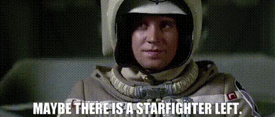 The image shows six identical frames of a man in a beige flight suit and helmet, seated in a cockpit. In each frame, he has…