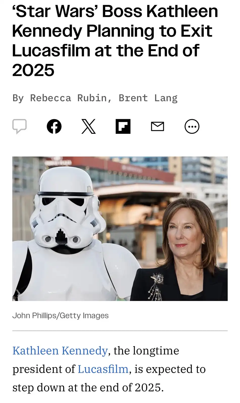 A screenshot of a news article shows a photo of Kathleen Kennedy standing next to a Stormtrooper. The headline and article…