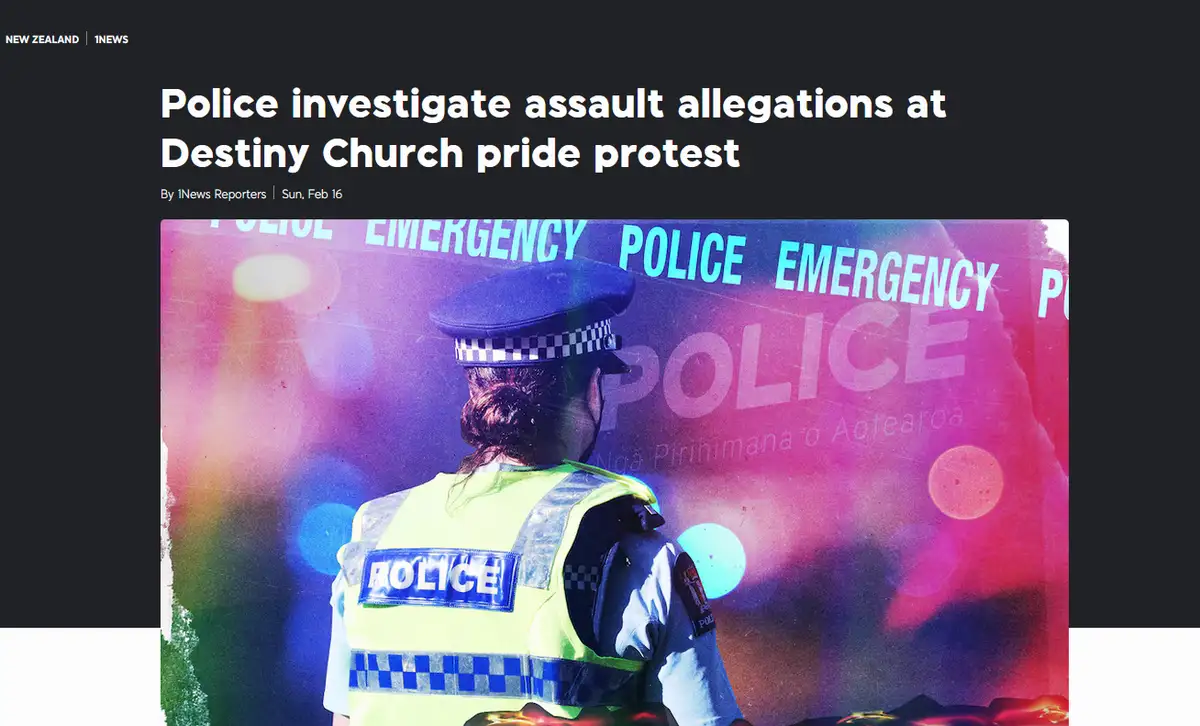 A news article screenshot shows a police officer in a high-visibility vest and cap, viewed from behind, standing against a…