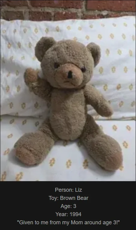 A brown, fluffy teddy bear sits upright on a white pillow with a yellow floral pattern, positioned against a red brick wall…