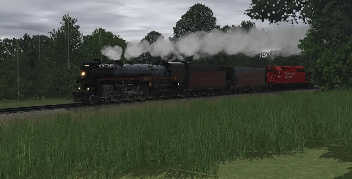 A steam locomotive, numbered 2816 and branded Canadian Pacific, pulls a train through a grassy field under an overcast sky…