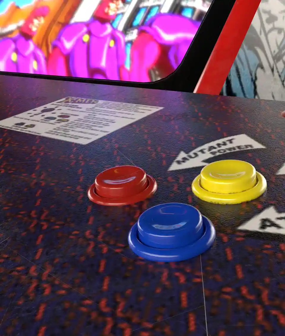 A close-up of an X-Men arcade game control panel showing three large colored buttons (red, yellow, blue) on a dark textured…