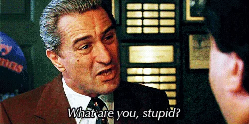 A meme featuring a sequence of three identical frames showing actor Robert De Niro as a character in a brown suit, angrily…