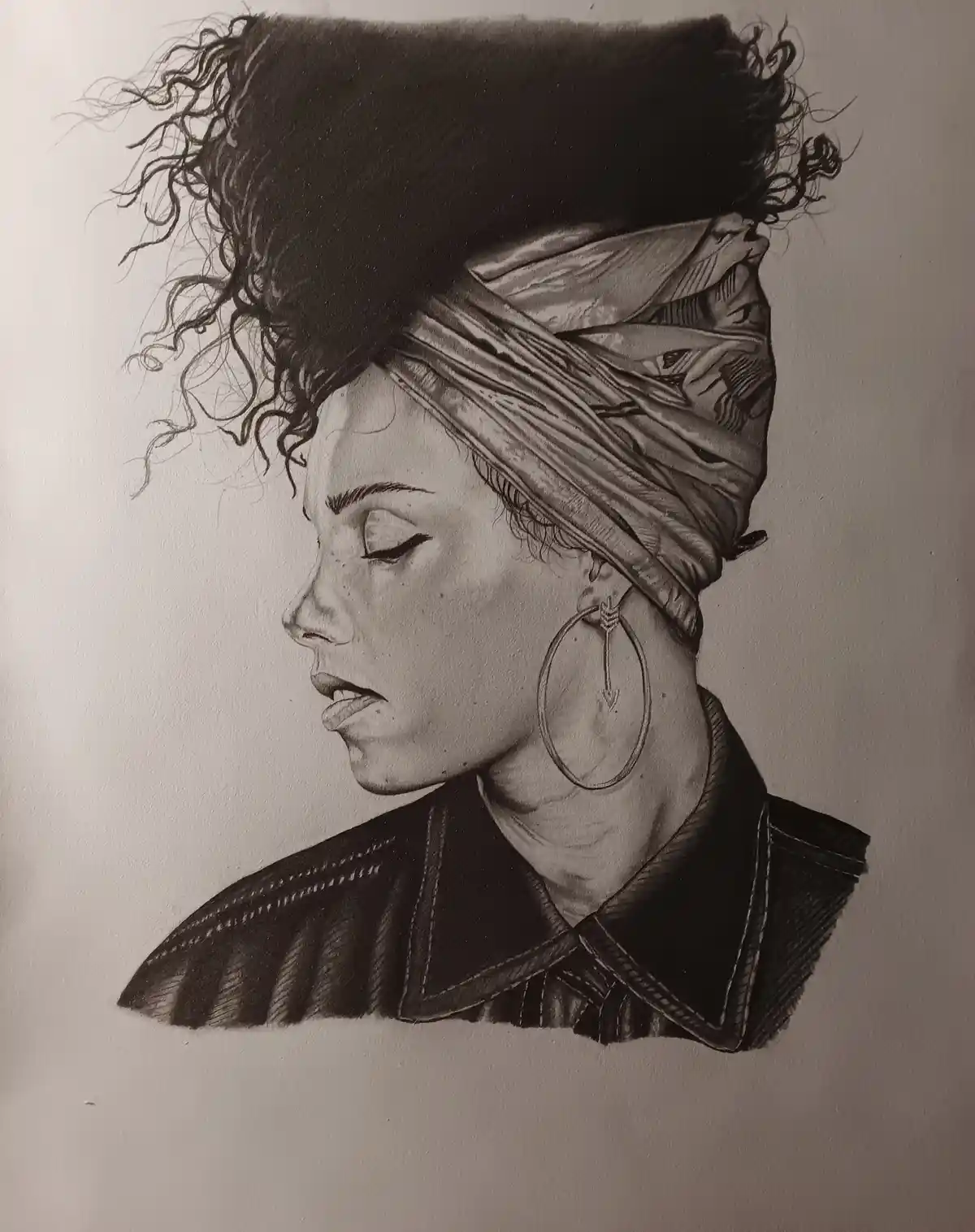 A detailed black-and-white pencil drawing shows a woman in profile, her eyes closed and lips slightly parted, wearing a…