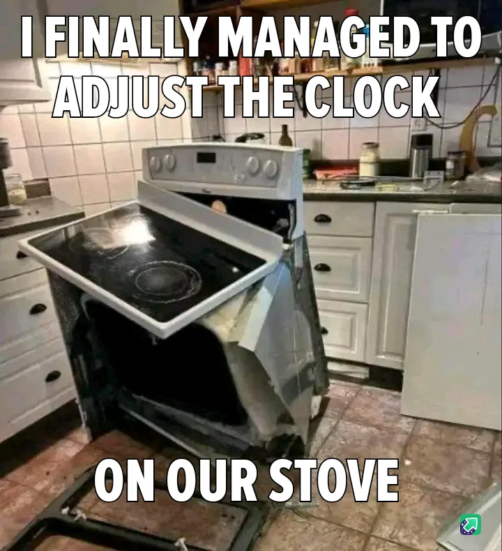A severely damaged white electric stove in a kitchen, with its front panel ripped off and the oven door hanging open…