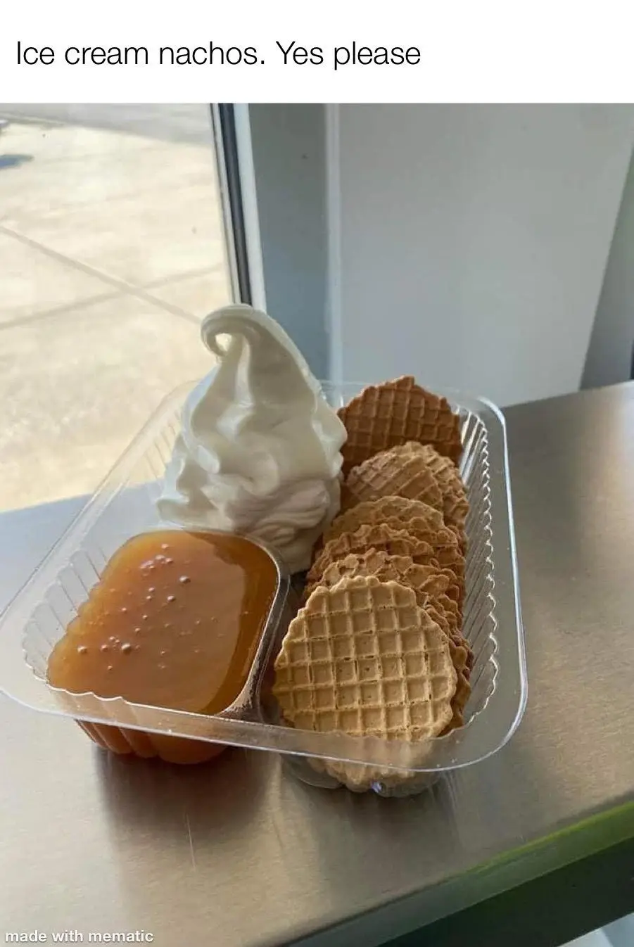 A clear plastic container holds a swirl of white soft-serve ice cream, a side of caramel sauce, and a pile of waffle cookies…