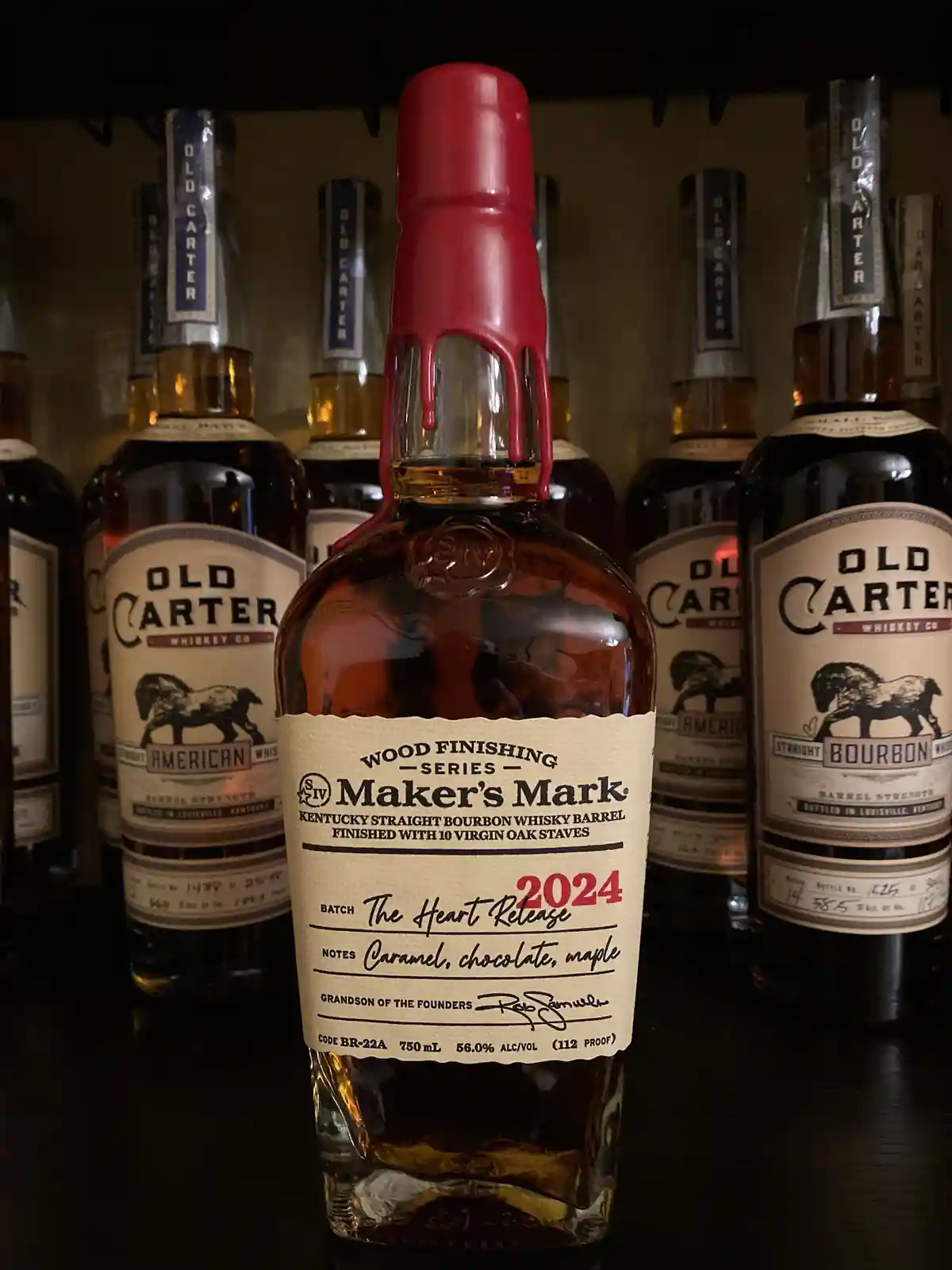 A bottle of Maker's Mark 2024 'The Heart Release' bourbon, distinguished by its red wax seal dripping down the neck, sits…