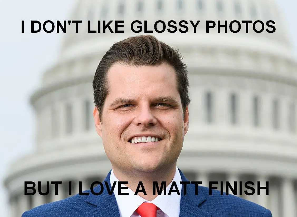A man in a blue suit and red tie smiles in front of the U.S. Capitol building. The image has bold black text overlaid at the…