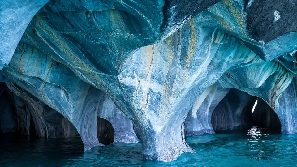 Take a boat ride across a glacial lake to discover Chile's Marble Caves. This stunning cavern appears vast at first, but…