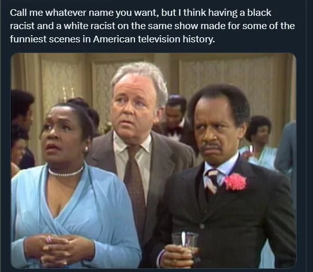 A still from a TV show featuring three people: a Black man in a suit with a pink flower on his lapel holding a glass, a…