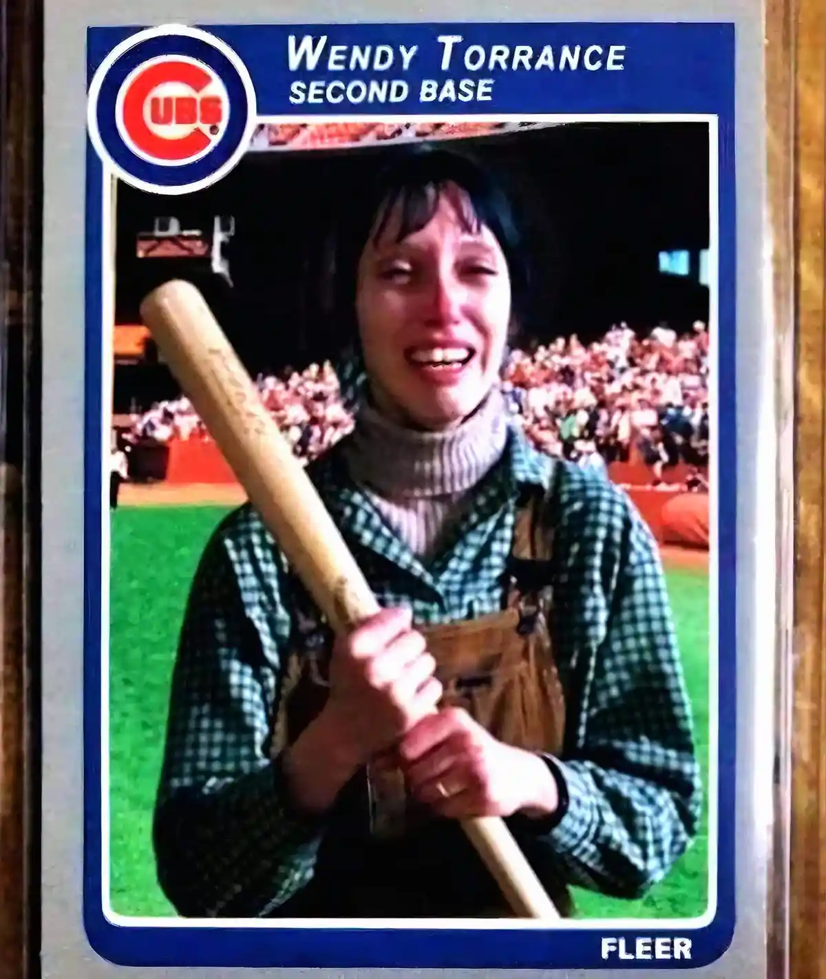 A vintage-style baseball card features a woman in overalls and a plaid shirt holding a baseball bat, with the Chicago Cubs…
