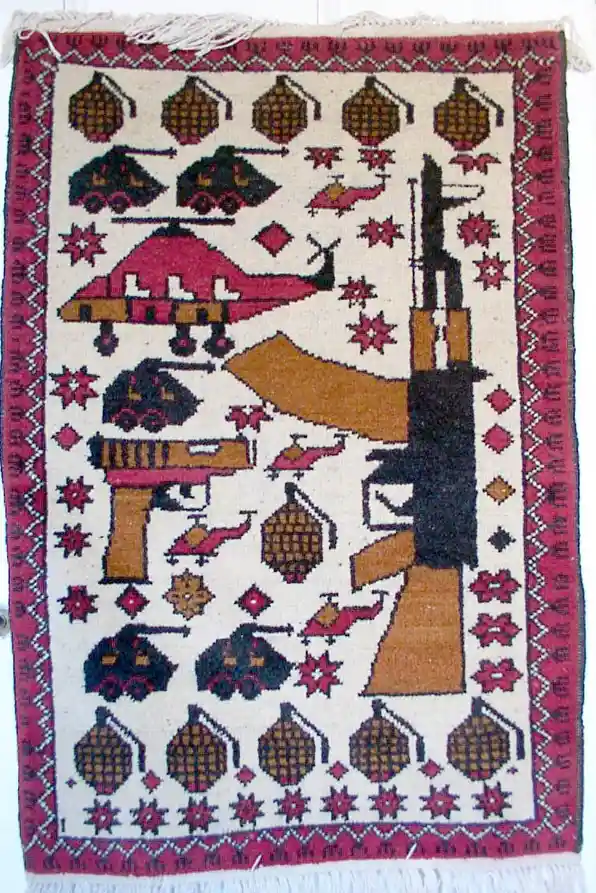 a hand-knotted rug with a cream background and red border, featuring stylized depictions of military weapons including…
