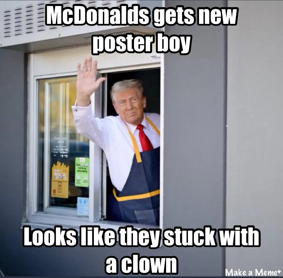A man with blond hair, wearing a white shirt, red tie, and blue apron with yellow trim, waves from inside a McDonald's…