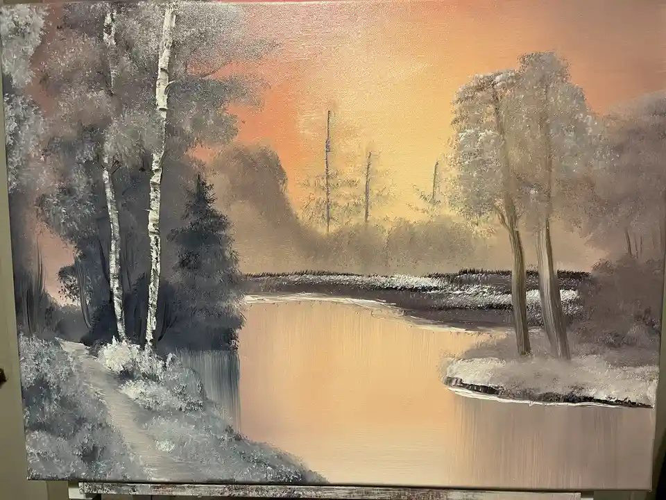 A painting of a winter landscape with birch trees, a frozen river, and a snowy foreground under an orange sky, overlaid with…