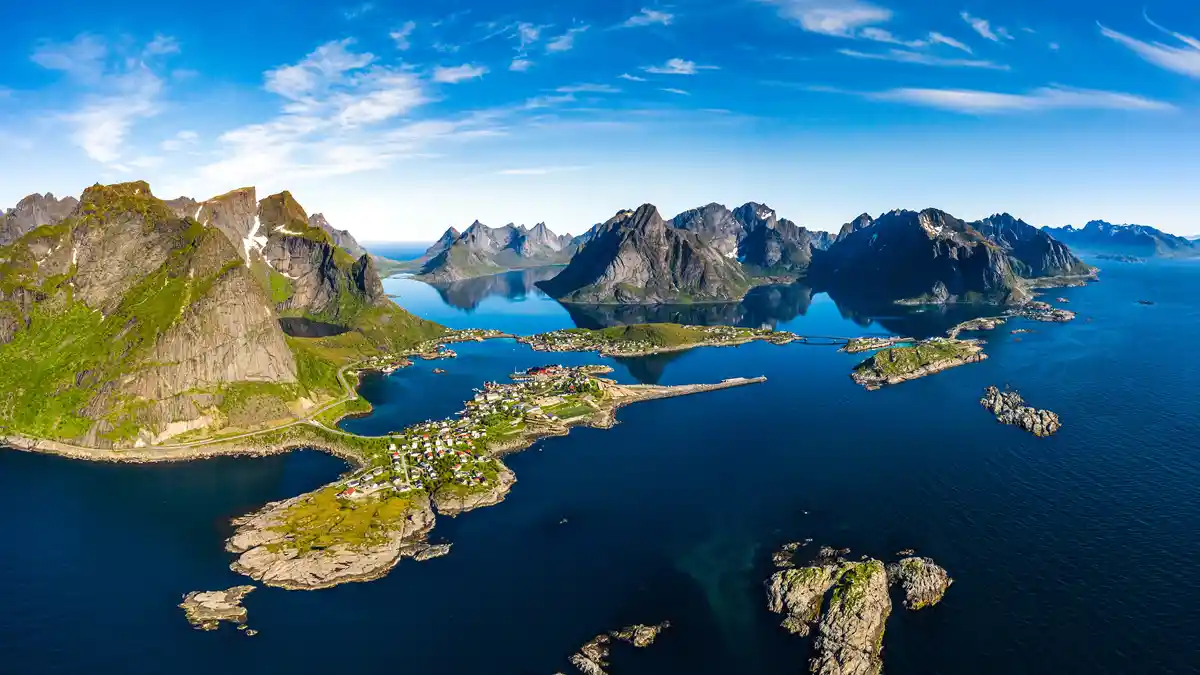 Drive the European route E10 through Norway's Lofoten Islands, flanked by fjords, and marvel at the breathtaking scenery…