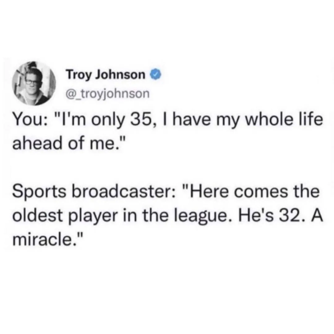 The image displays a screenshot of a tweet by Troy Johnson, showing a humorous exchange where a person claims to have a long…