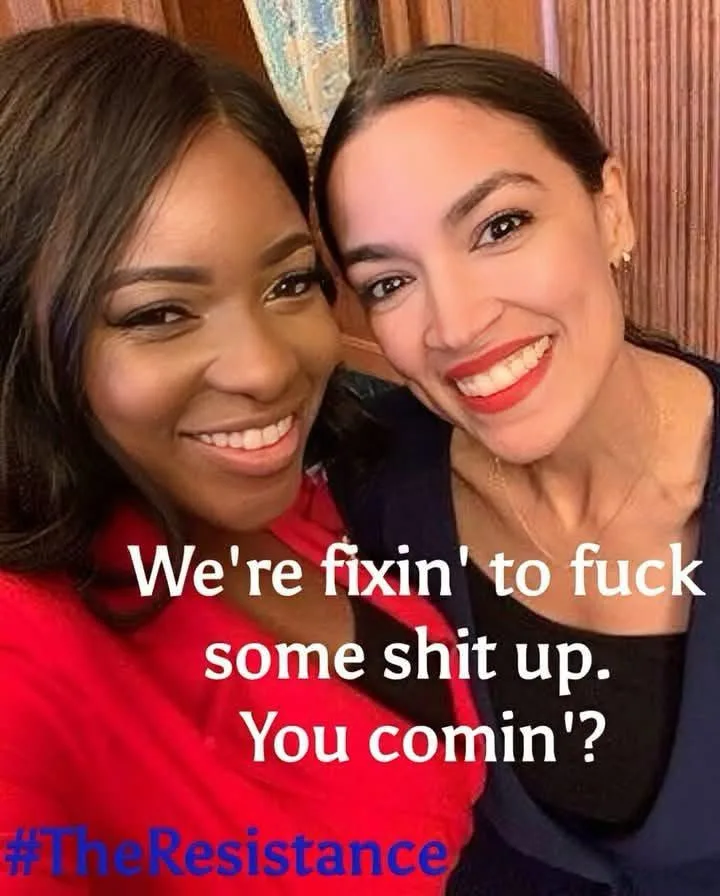Two smiling women pose closely for a selfie, one in a red top and the other in a dark blue top, with bold white text…