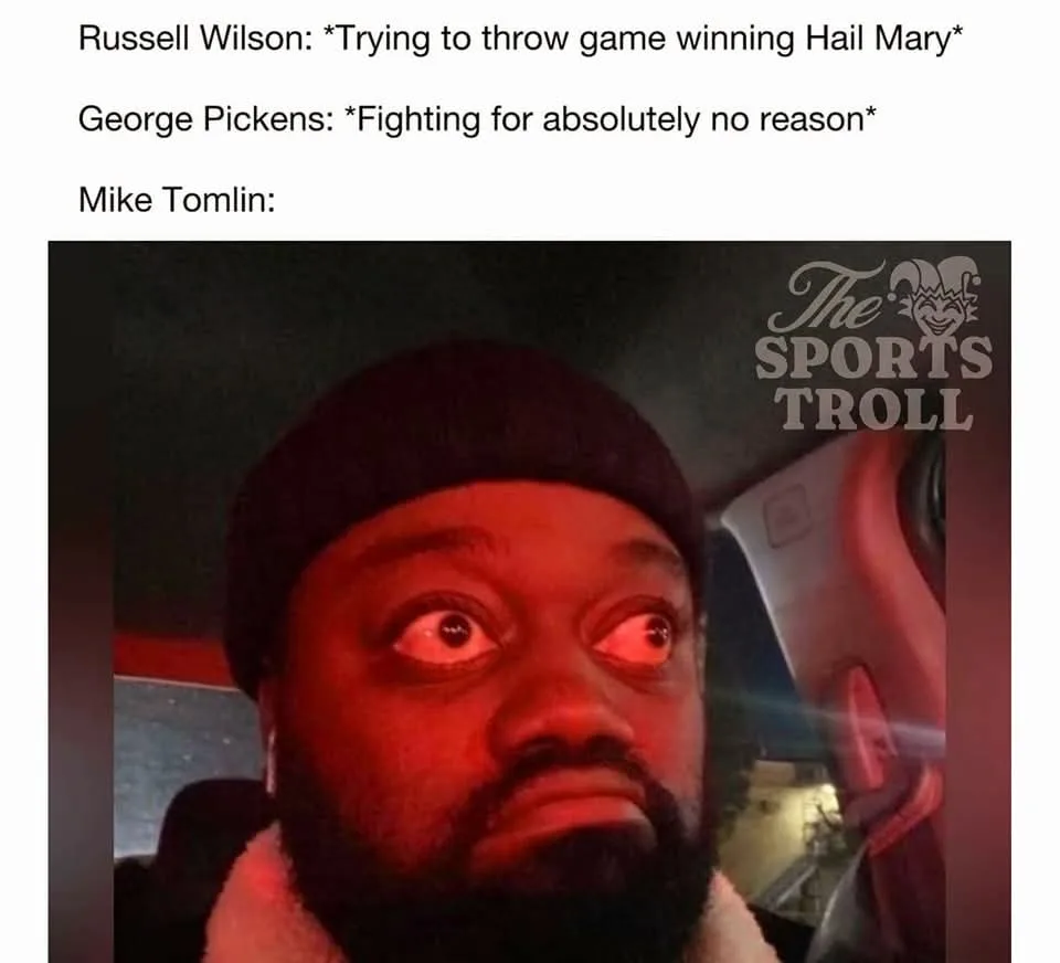 A man with a beard and beanie stares with wide, startled eyes under red lighting, likely inside a car, with 'The Sports…