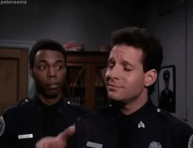 six panels show two police officers; the officer on the right makes a 'shushing' gesture, then a 'finger gun' motion, then a…