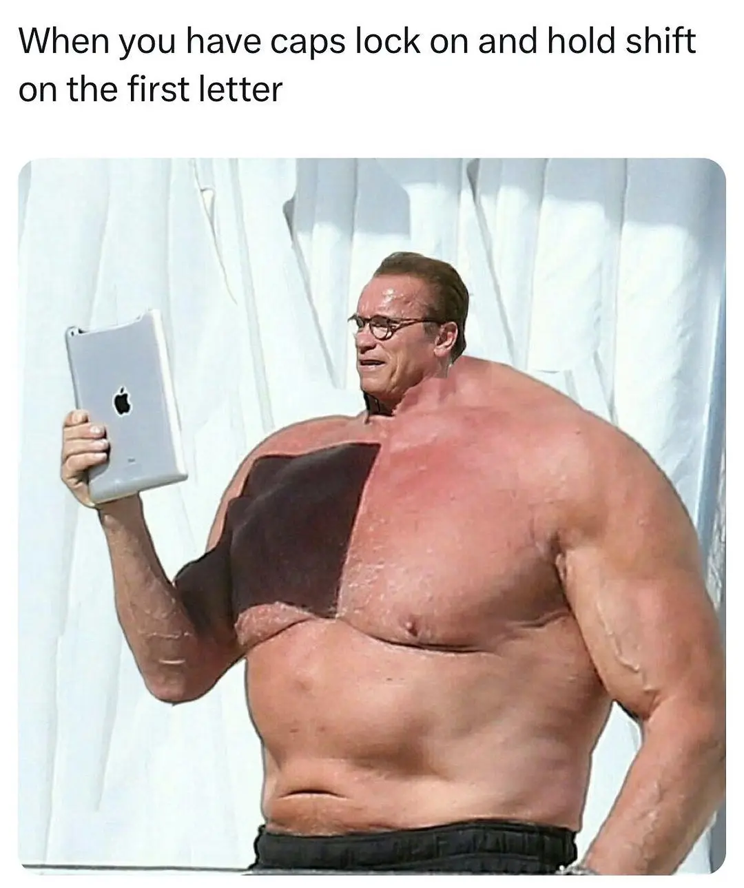 A muscular man, resembling Arnold Schwarzenegger, holds a silver Apple tablet while looking at it. His torso is split down…
