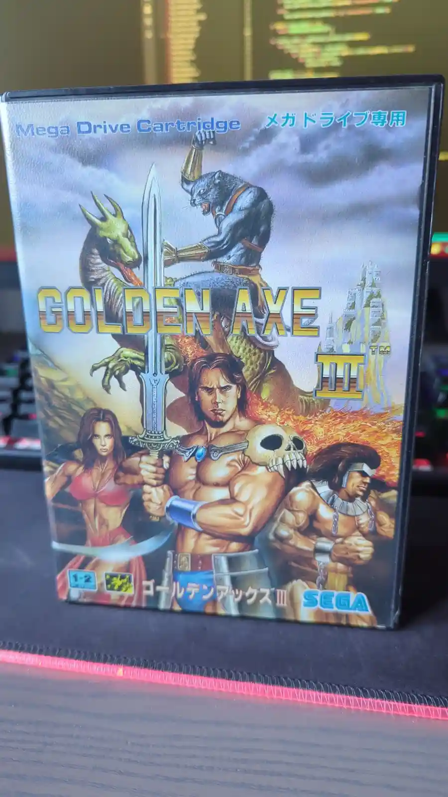 A physical game cartridge box for 'Golden Axe III' for the Sega Mega Drive, featuring artwork of a central muscular warrior…