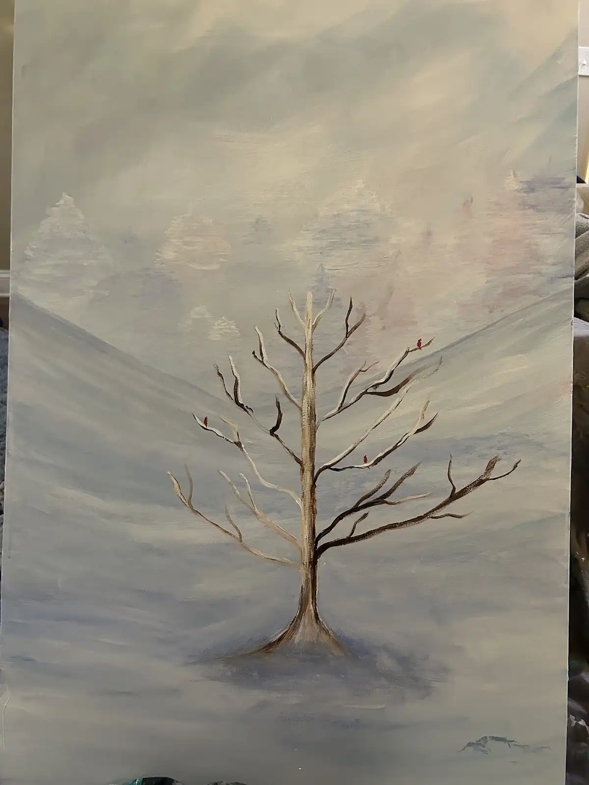 A painting of a bare, leafless tree standing in a snowy landscape with faint, distant mountains under a muted sky. Three…