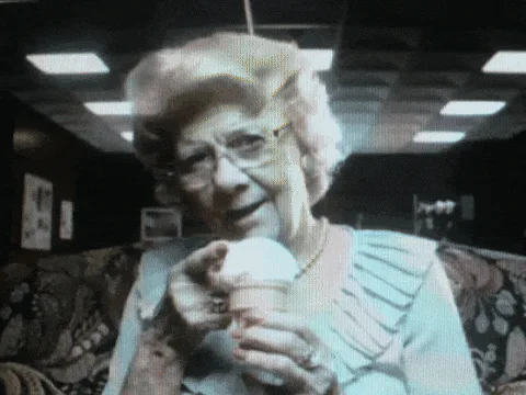 A six-panel image sequence shows an elderly woman with glasses holding and eating an ice cream cone. The panels progress…