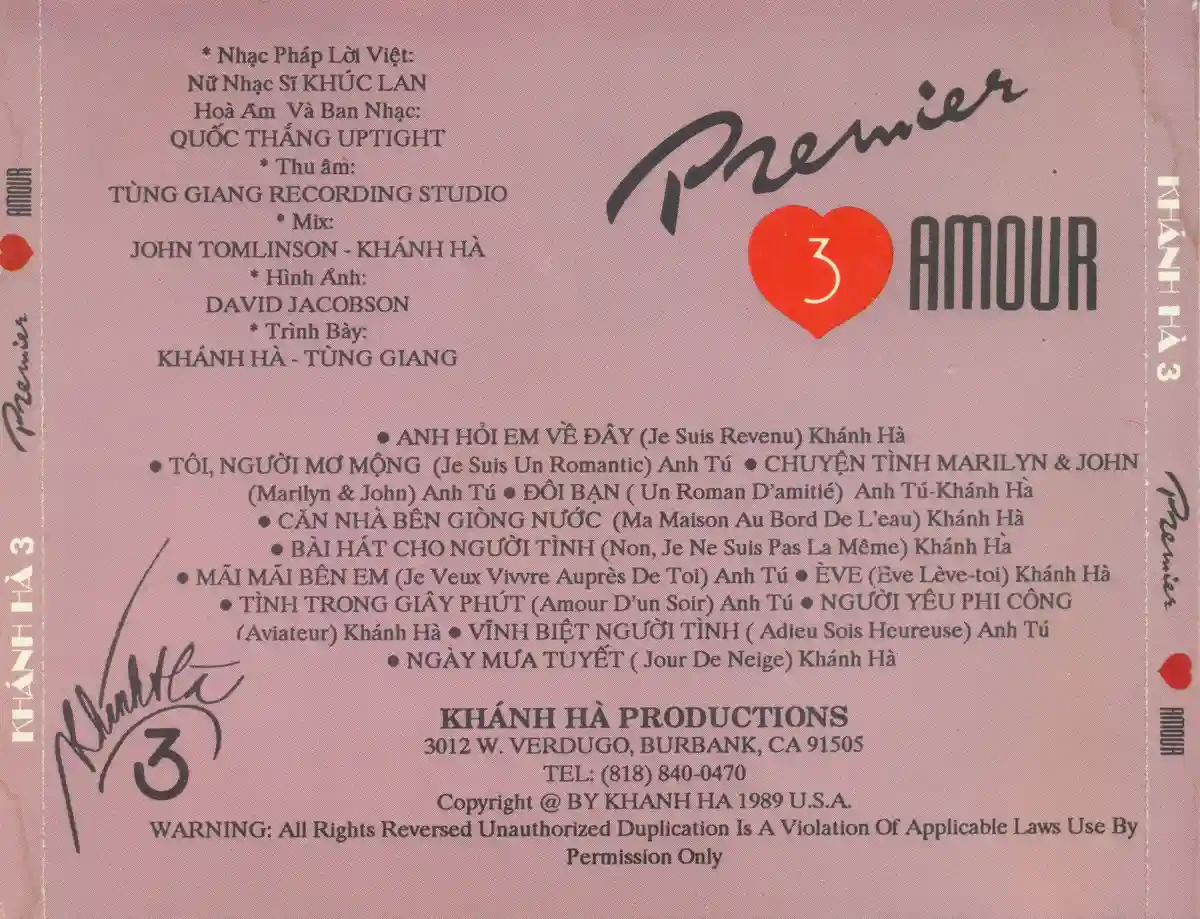 The image shows the back cover of a pink cassette tape labeled 'Premier 3 AMOUR', featuring a red heart with the number 3…