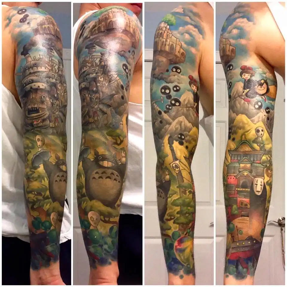 A person's full sleeve tattoo depicts scenes from Studio Ghibli films, including Totoro, the sky castle from Howl's Moving…