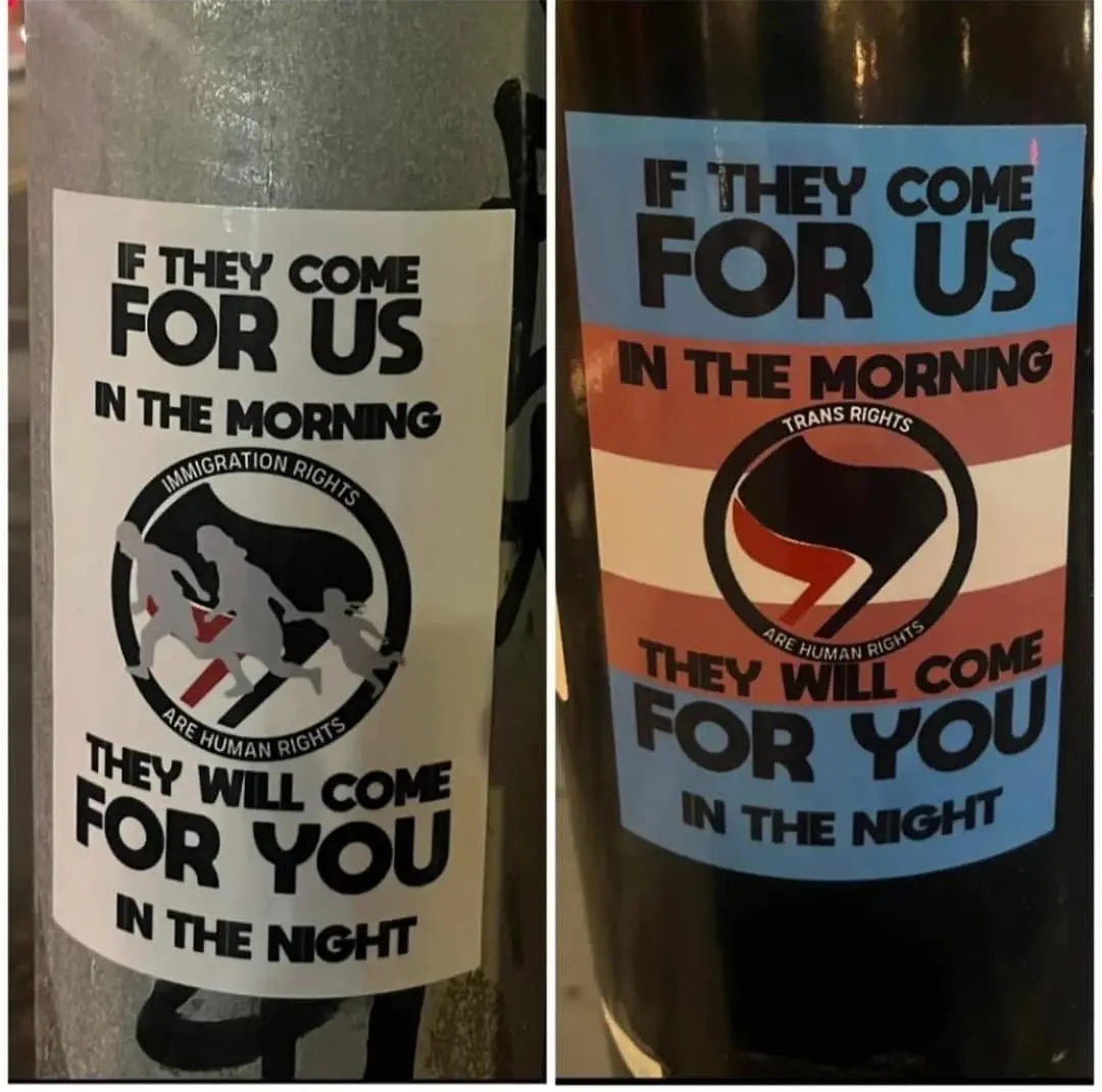 Two side-by-side stickers on cylindrical surfaces. The left sticker, on a gray pole, reads 'IF THEY COME FOR US IN THE…