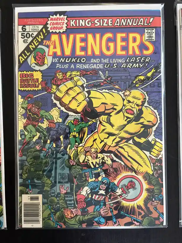 A vintage 1976 Marvel Comics Group Avengers Annual #6 comic book cover, featuring a dynamic battle scene with the Avengers…