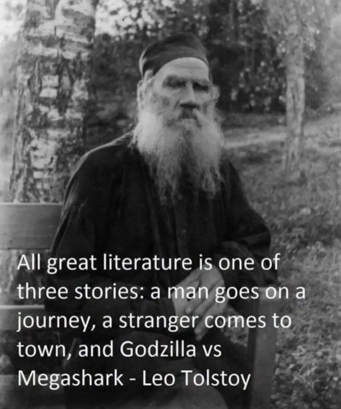 A black-and-white photograph of Leo Tolstoy, an elderly man with a long white beard and a dark cap, seated outdoors on a…