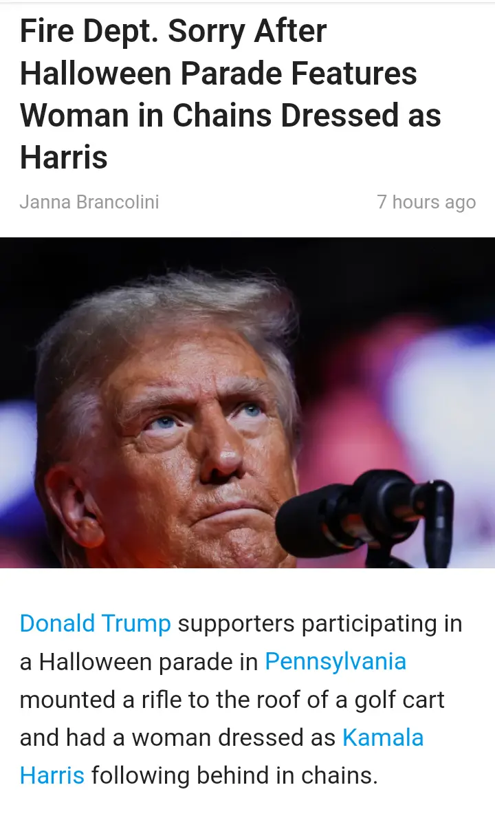 The image shows a close-up of Donald Trump looking upward with a serious expression, positioned in front of a microphone…