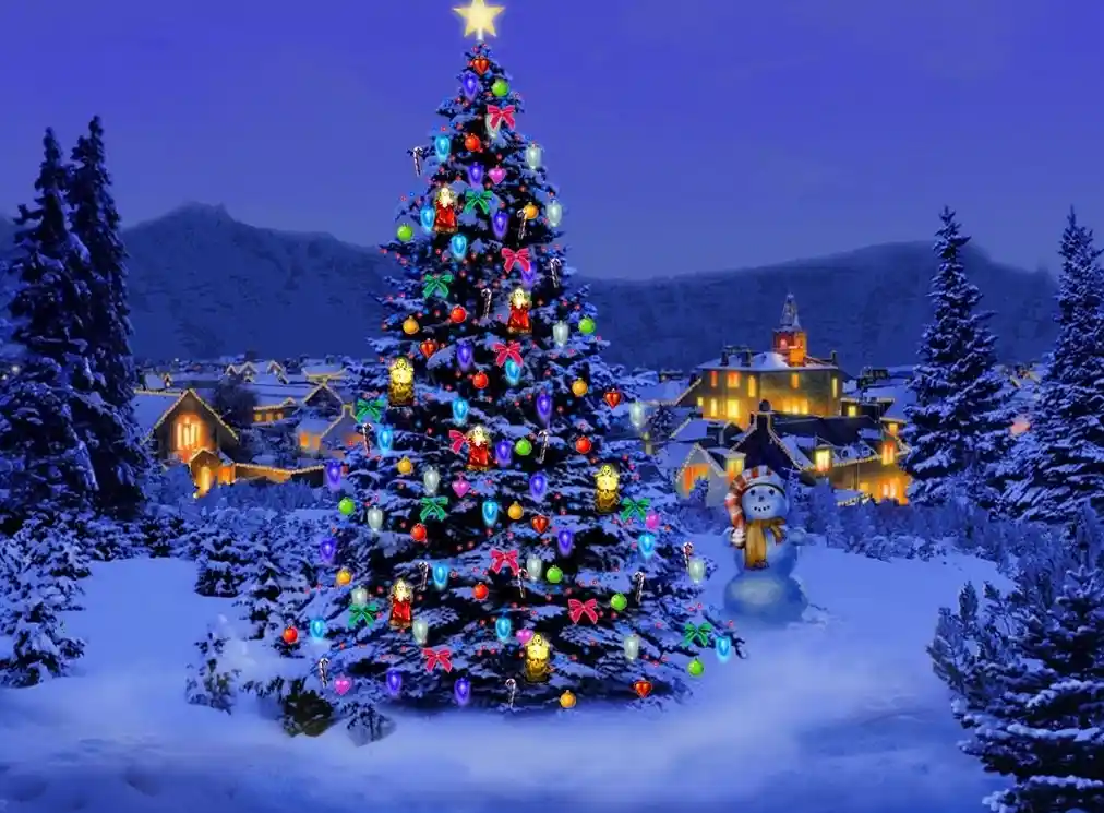 A large, brightly lit Christmas tree decorated with colorful ornaments, candy canes, and lights stands in a snowy village at…