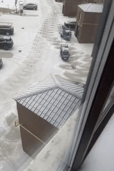 A sequence of images shows a blue pickup truck with a snowplow attachment clearing snow from a residential driveway and…