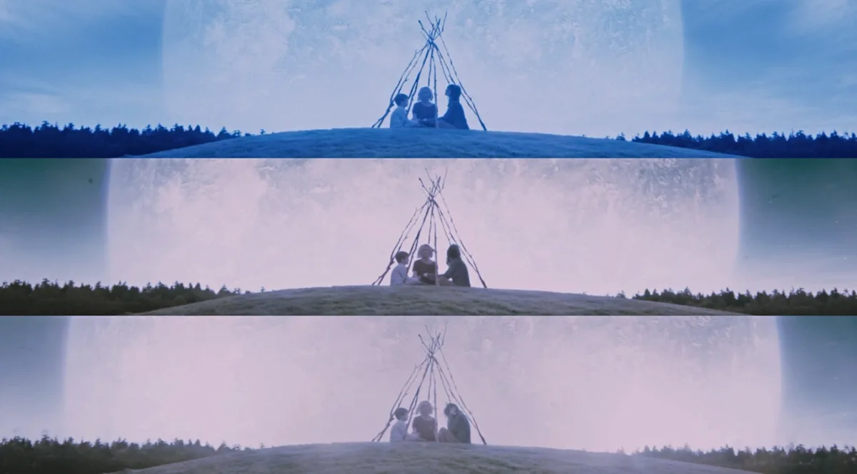 three stacked frames show three people sitting under a teepee on a hill, with a massive moon in the background that…