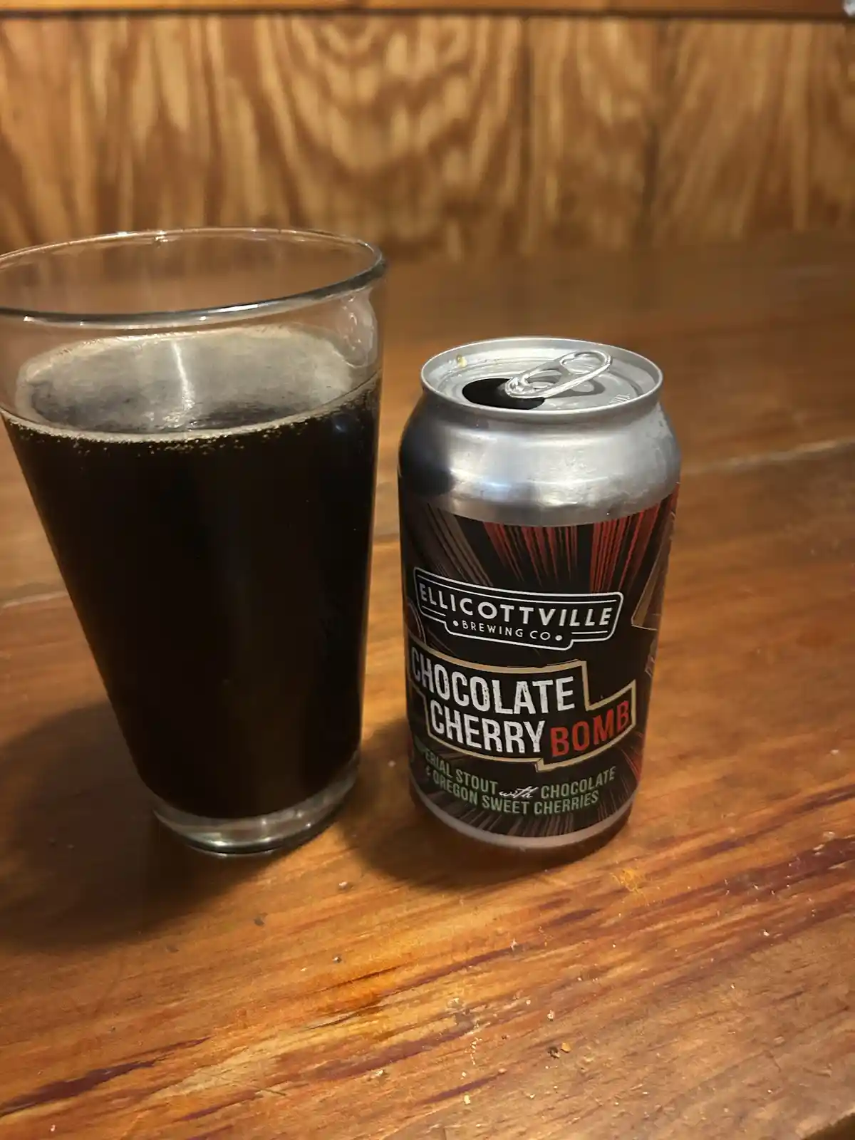 A can of Ellicottville Brewing Co.'s 'Chocolate Cherry Bomb' imperial stout sits next to a glass filled with the dark beer…