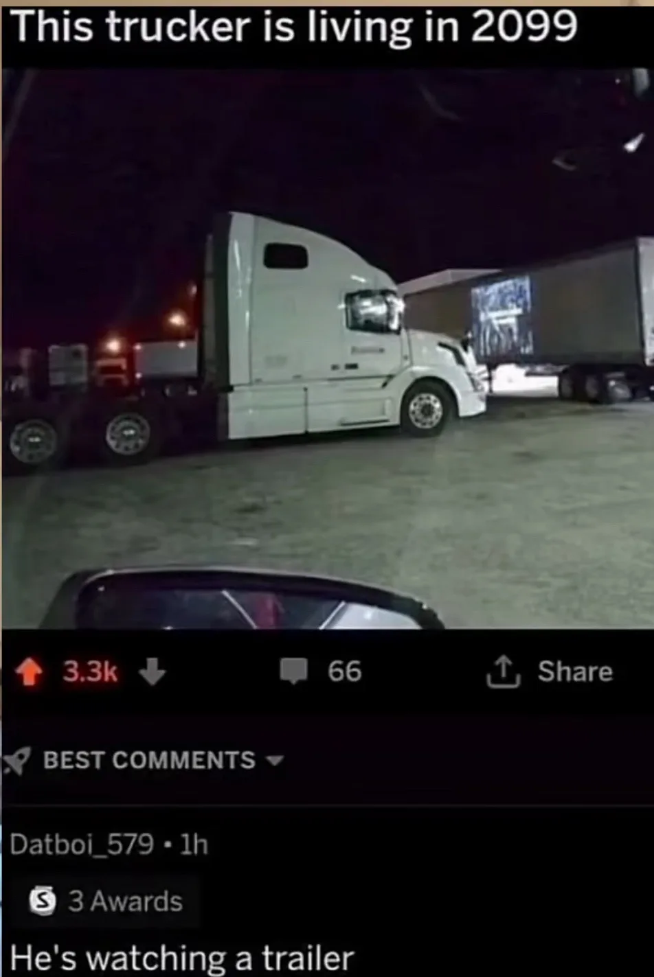 A nighttime dashcam view shows a white semi-truck parked in a lot, with its trailer displaying a bright, moving image…
