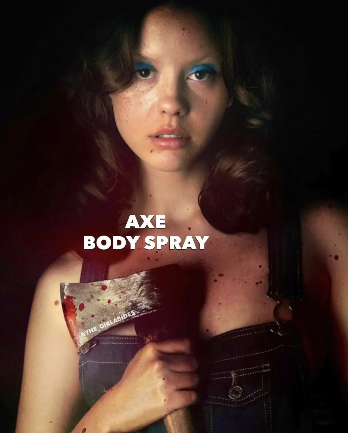 A woman with freckles and blue eyeshadow holds a bloody axe while wearing overalls, with the text 'AXE BODY SPRAY' overlaid…