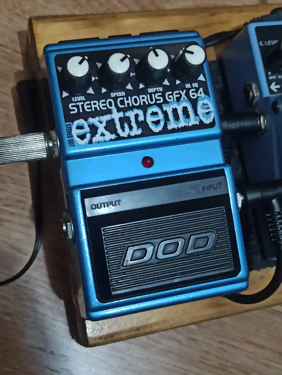 A blue DOD Stereo Chorus GFX 64 guitar effects pedal with four white knobs labeled Level, Speed, Depth, and HL EQ, has the…